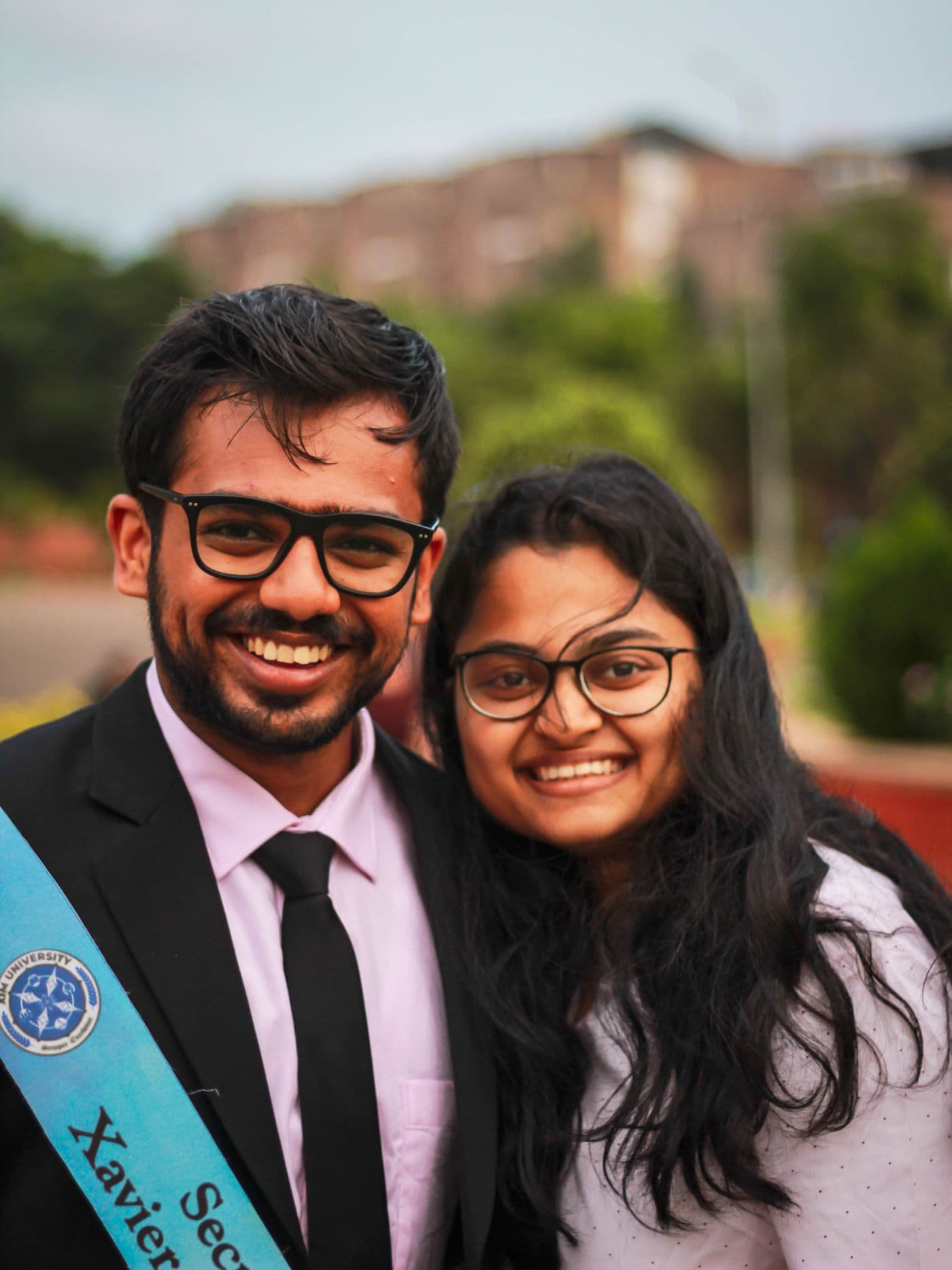 Two Indian graduates celebrating outdoors